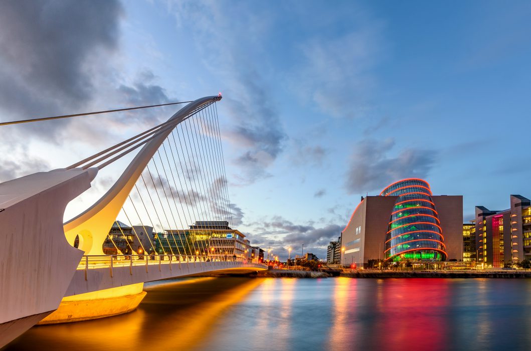 Barrel shaped Dublin Convention Center and Samuel Beckett Bridge reflecting in the river Liffey, Dublin , Ireland